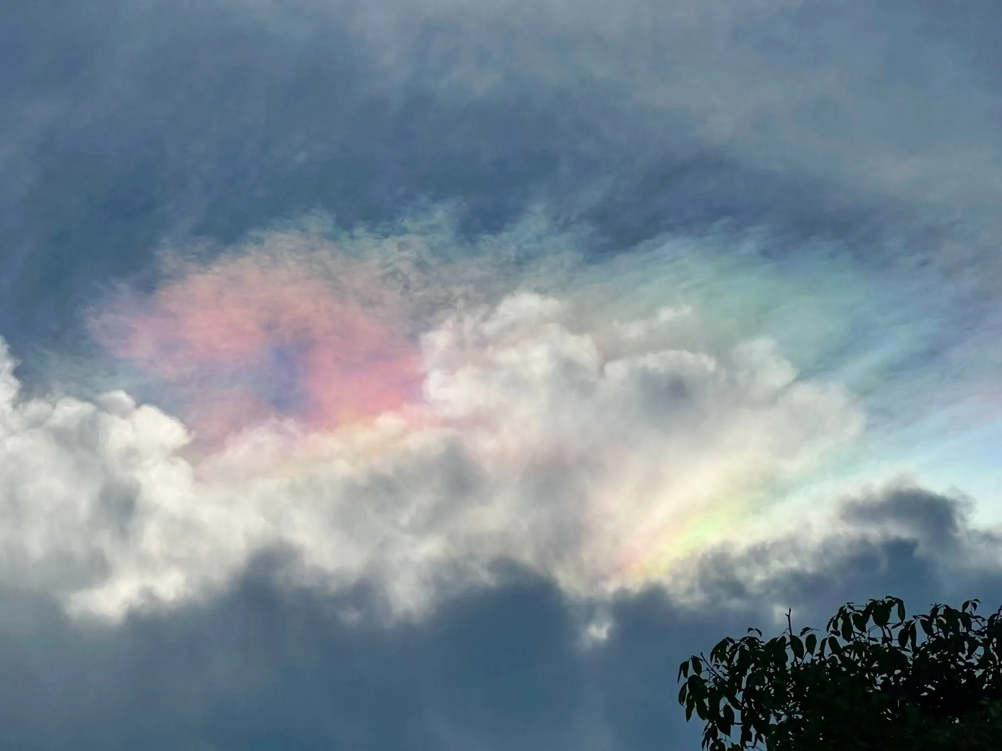 A glowing rainbow cloud over the JG Farm skyline